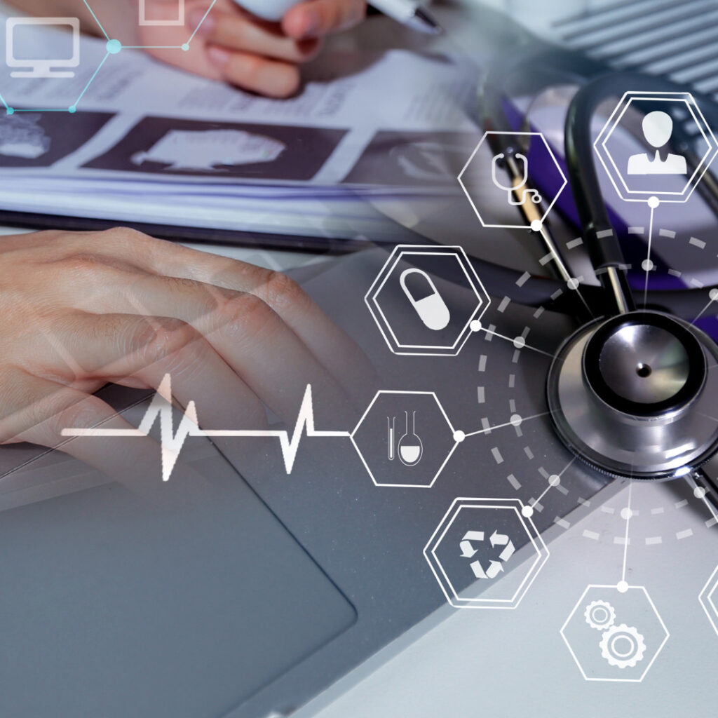 Hands using a laptop next to a stethoscope, overlaid with medical icons and an ECG line, illustrating medical research.