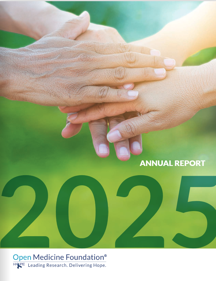 A close-up photo shows hands stacked together, symbolizing unity, support, and compassion. The background is a soft, blurred green. Overlaid text reads “Annual Report 2025. The OMF logo is at the bottom.
